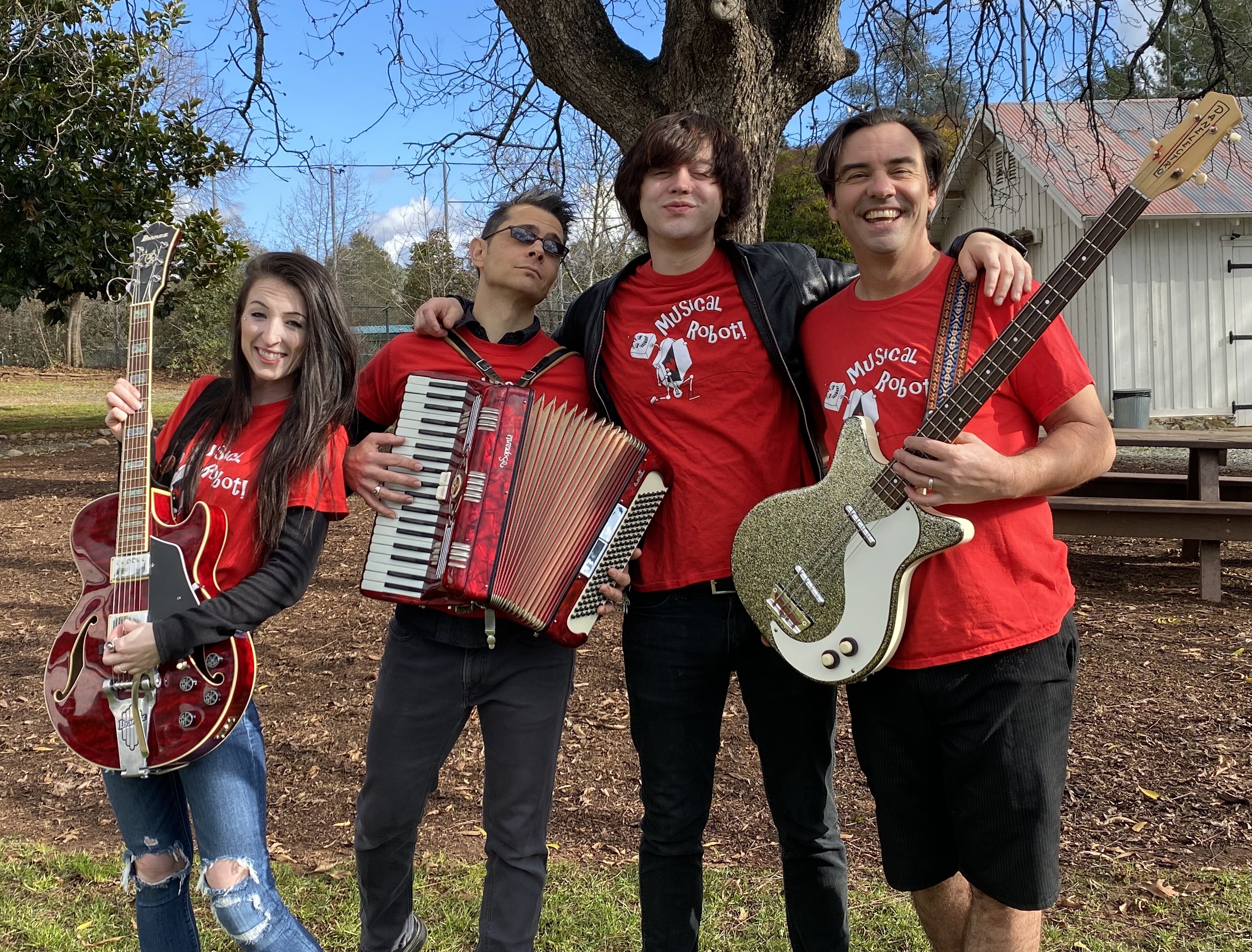 Four cool band mates under a tree. Jason Adair is blowing minds.