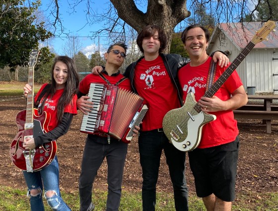 Four cool band mates under a tree. Jason Adair is blowing minds.