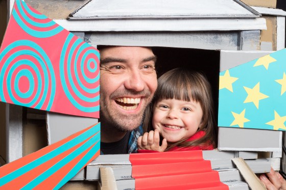 Posing inside a model of a building, Jason Adair shares a wonderful moment cheek to cheek with his best friend Audrey Luna